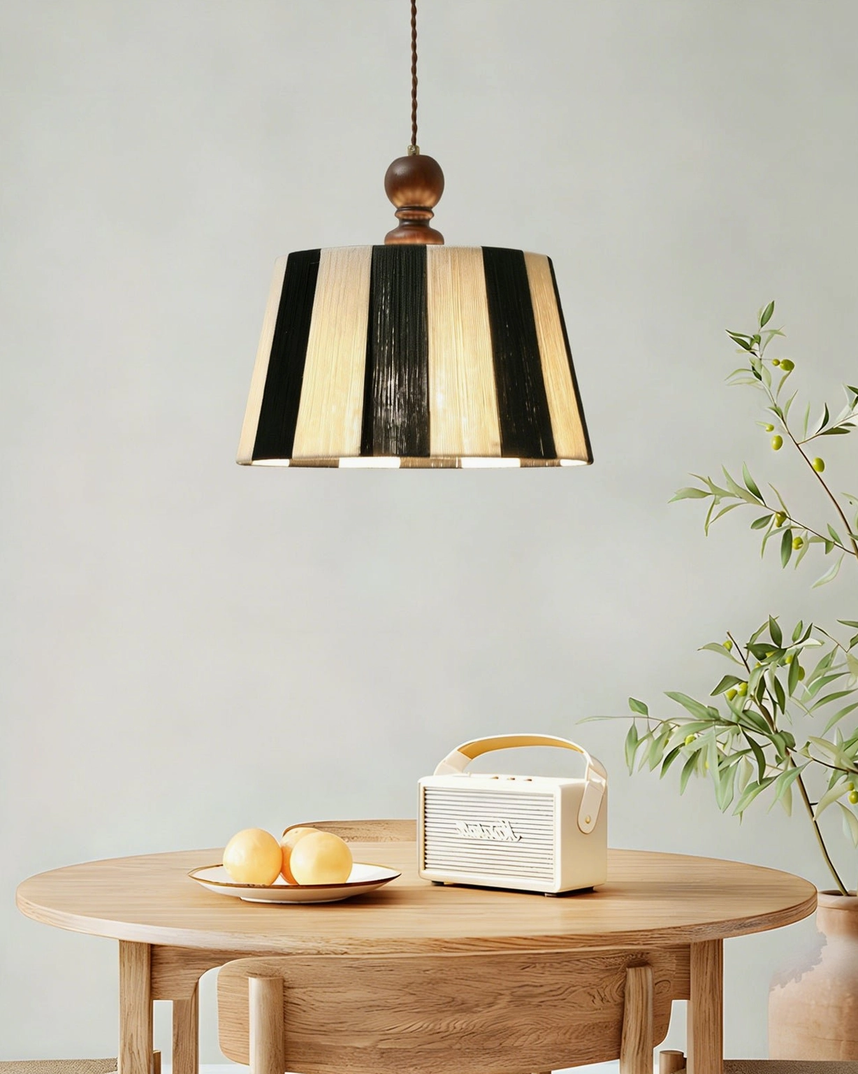 Beatrice black and beige striped pendant fixture overhead view in cozy dining corner with round wooden table