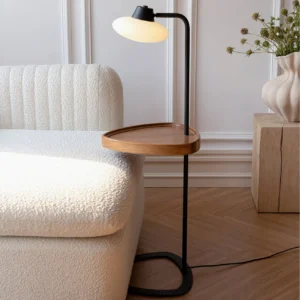 Beatrix floor lamp beside boucle sofa in cozy living room, warm neutral home décor, tray styled with decorative objects