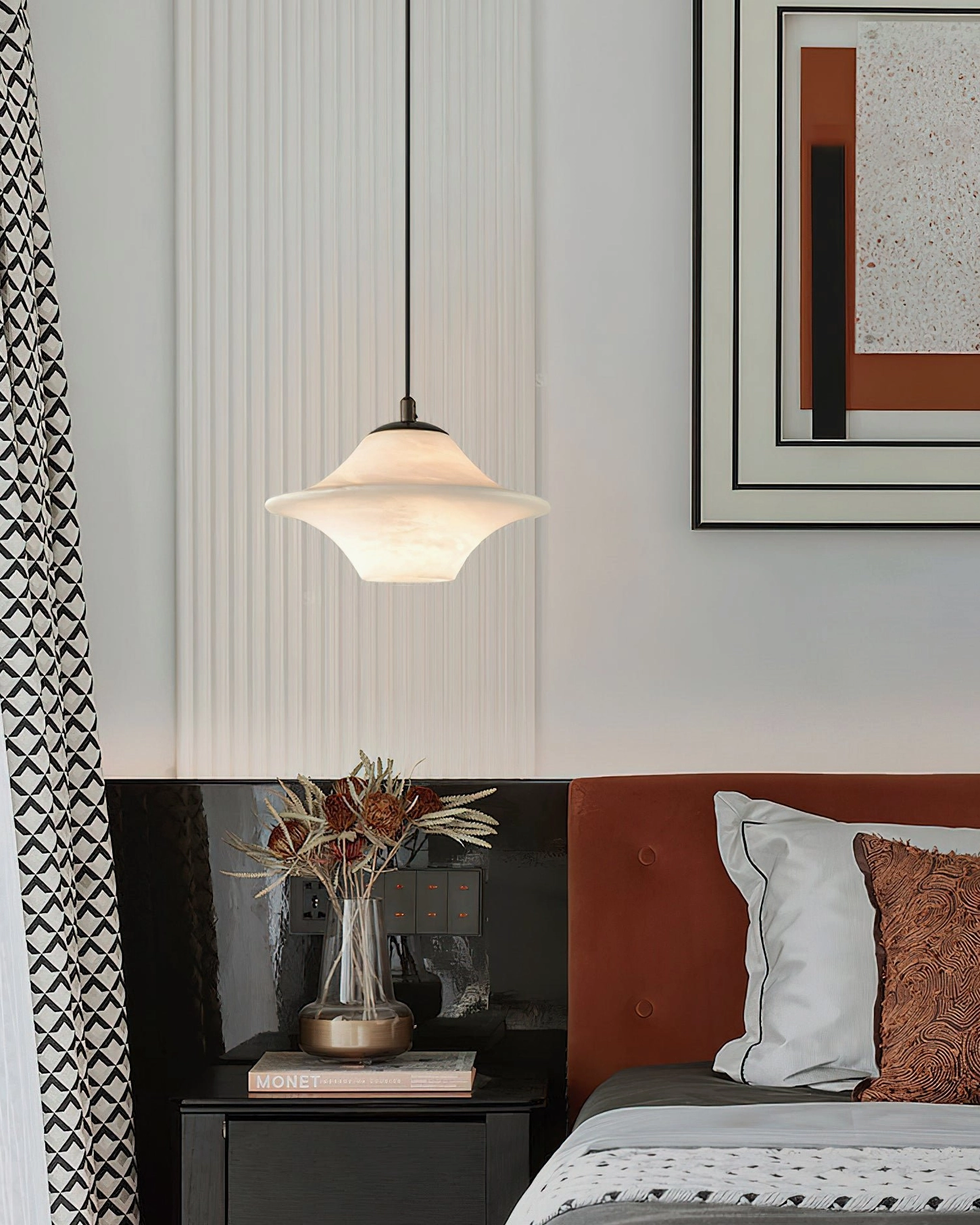 Beckett alabaster pendant light hanging over bedroom nightstand with wall art and warm neutral tones - transitional interior design