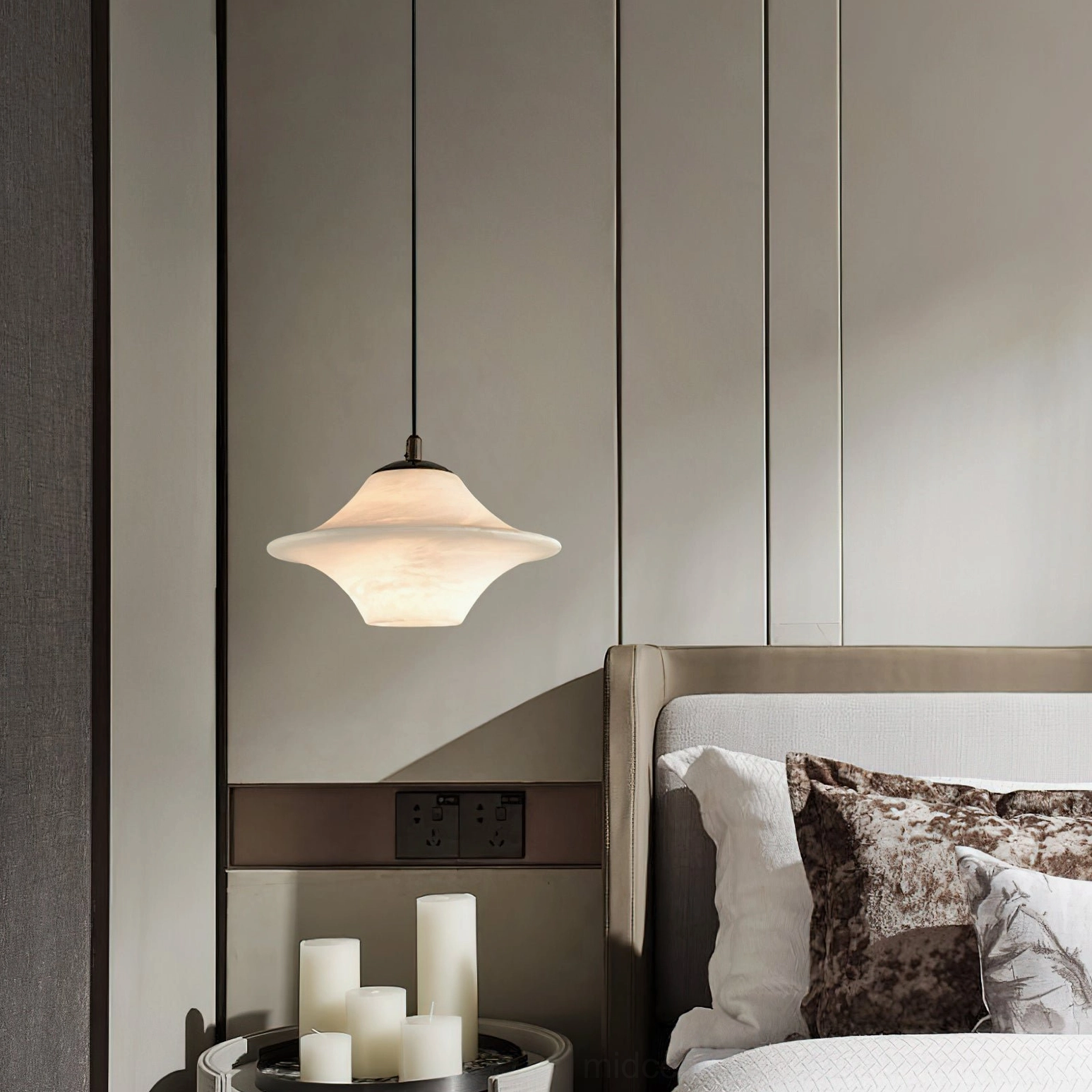 Beckett alabaster pendant light with dark metal suspension rod in modern bedroom with candle decor - warm neutral ambiance