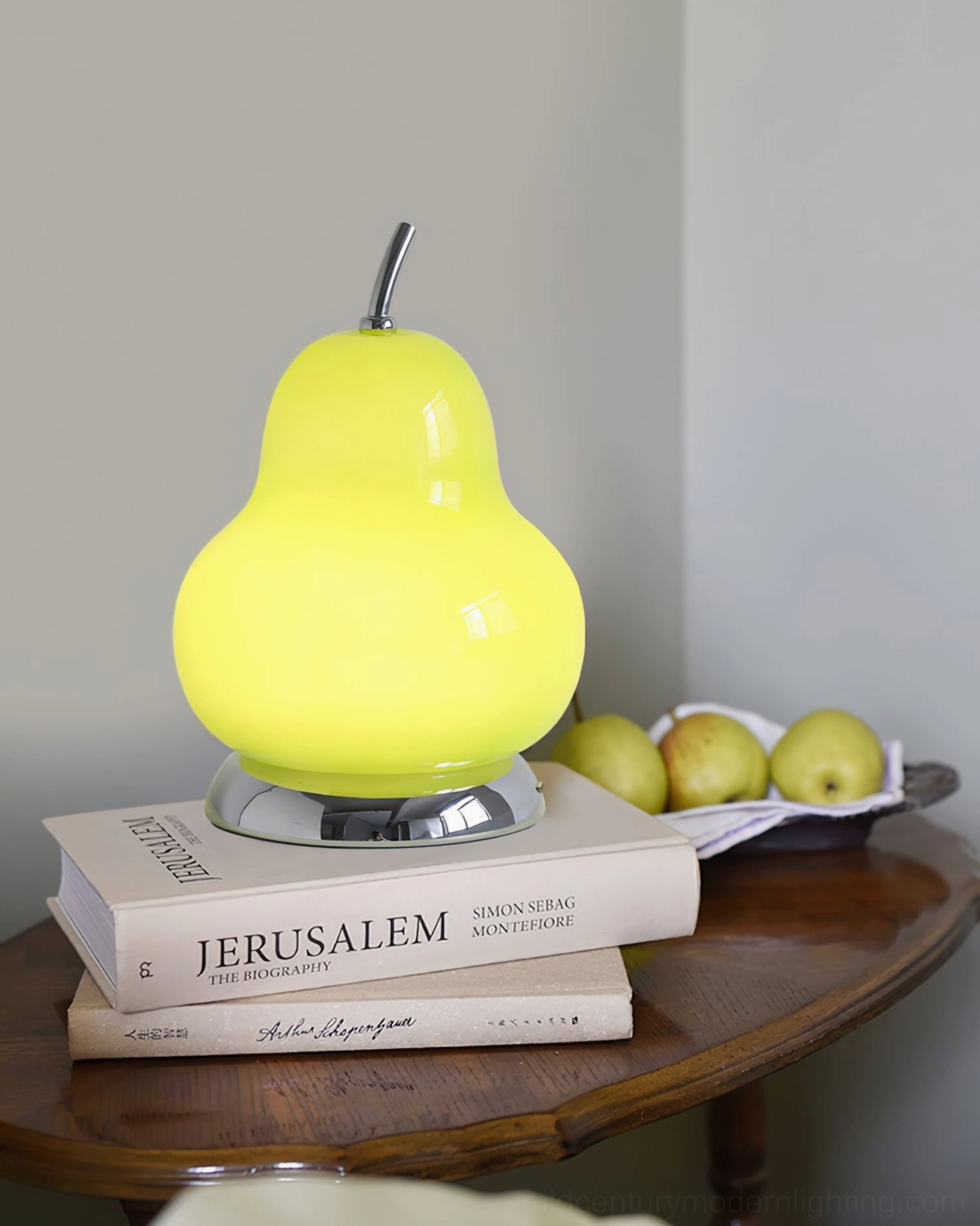 Glowing pear-shaped cordless table lamp on bedroom bedside surface with cozy ambient warmth and knit fabric styling