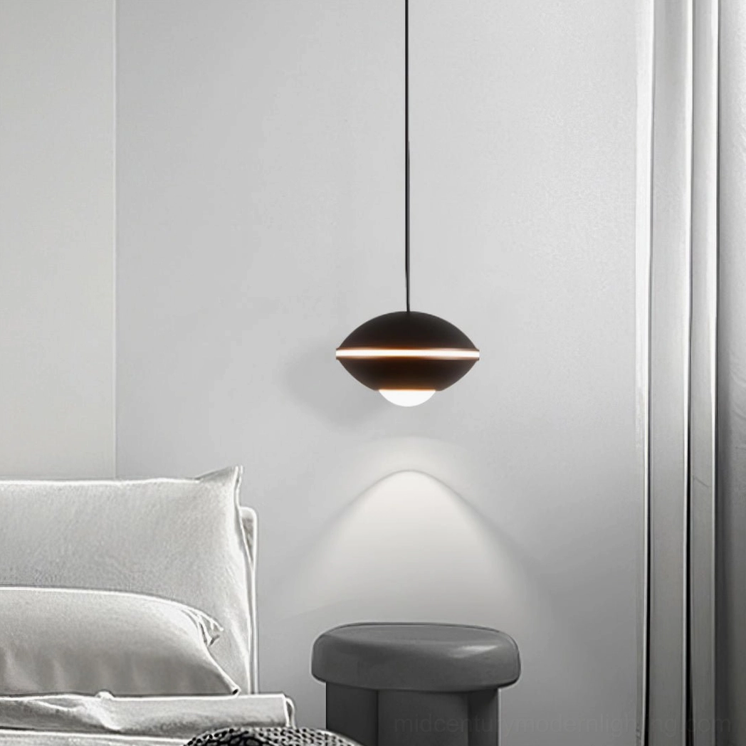 Modern matte black disc pendant light in contemporary bedroom setting, warm downlighting