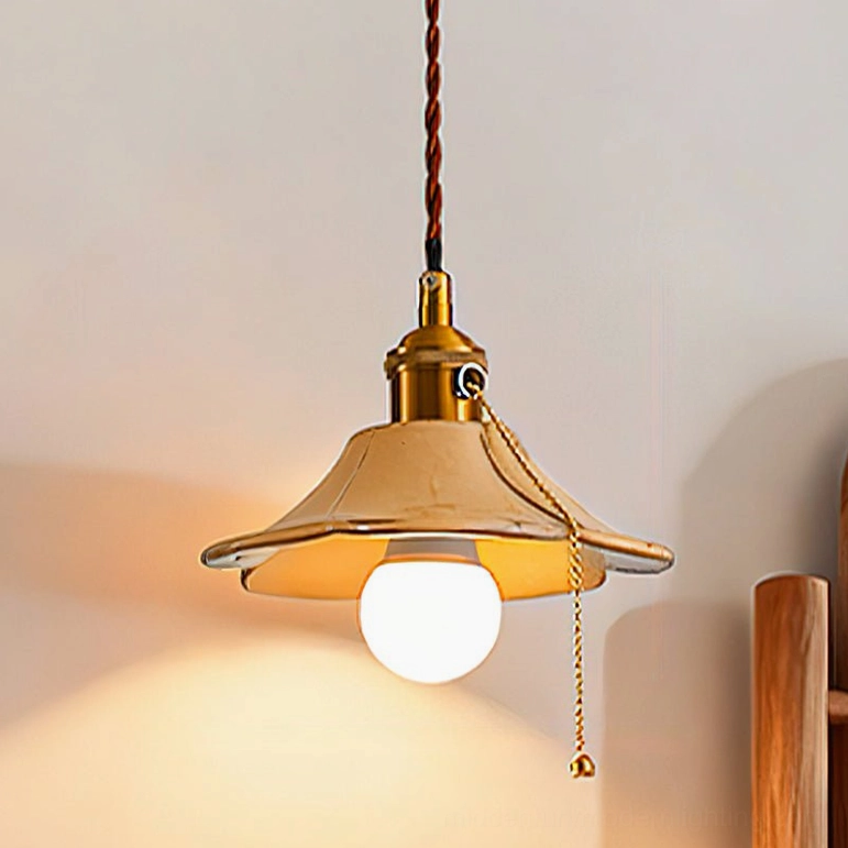 Beige grange ceramic pendant light with hand-printed design and brass hardware in various interior settings