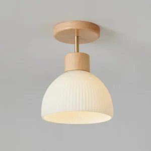Beige ceramic ribbed ceiling light fixture close-up, showing vertical fluted texture detail
