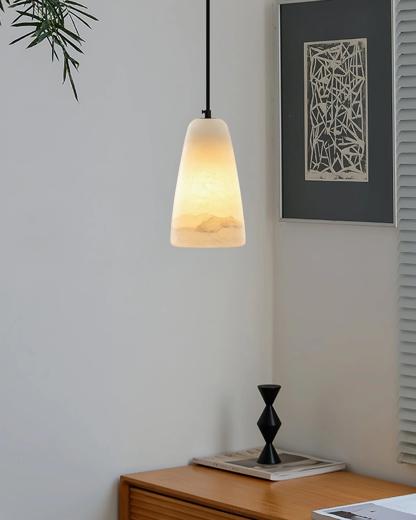 Belfry pendant lamp hanging in minimalist interior with black cord side profile view