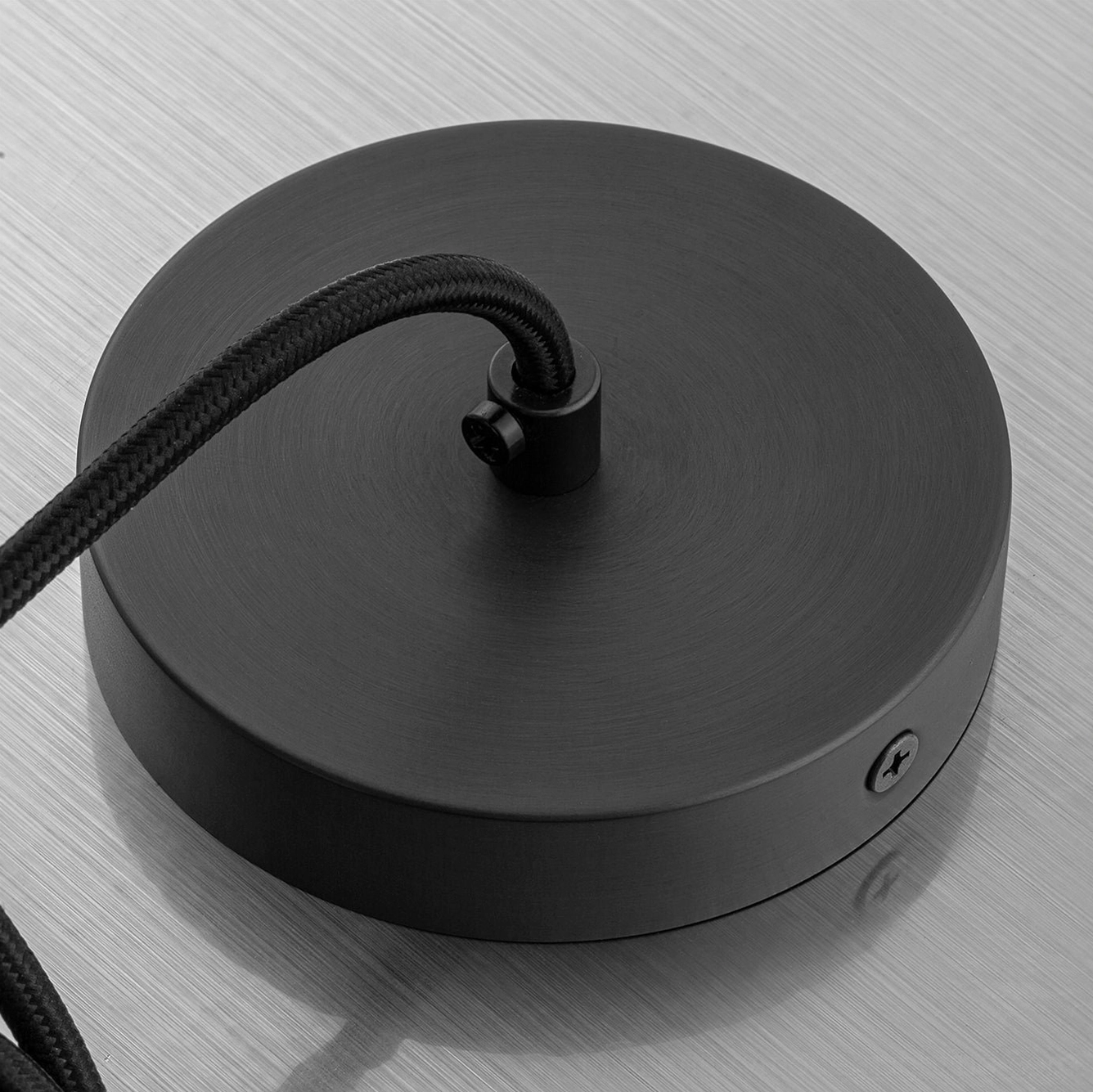Top-down view of Belfry pendant ceiling mount with black iron hardware and braided cord