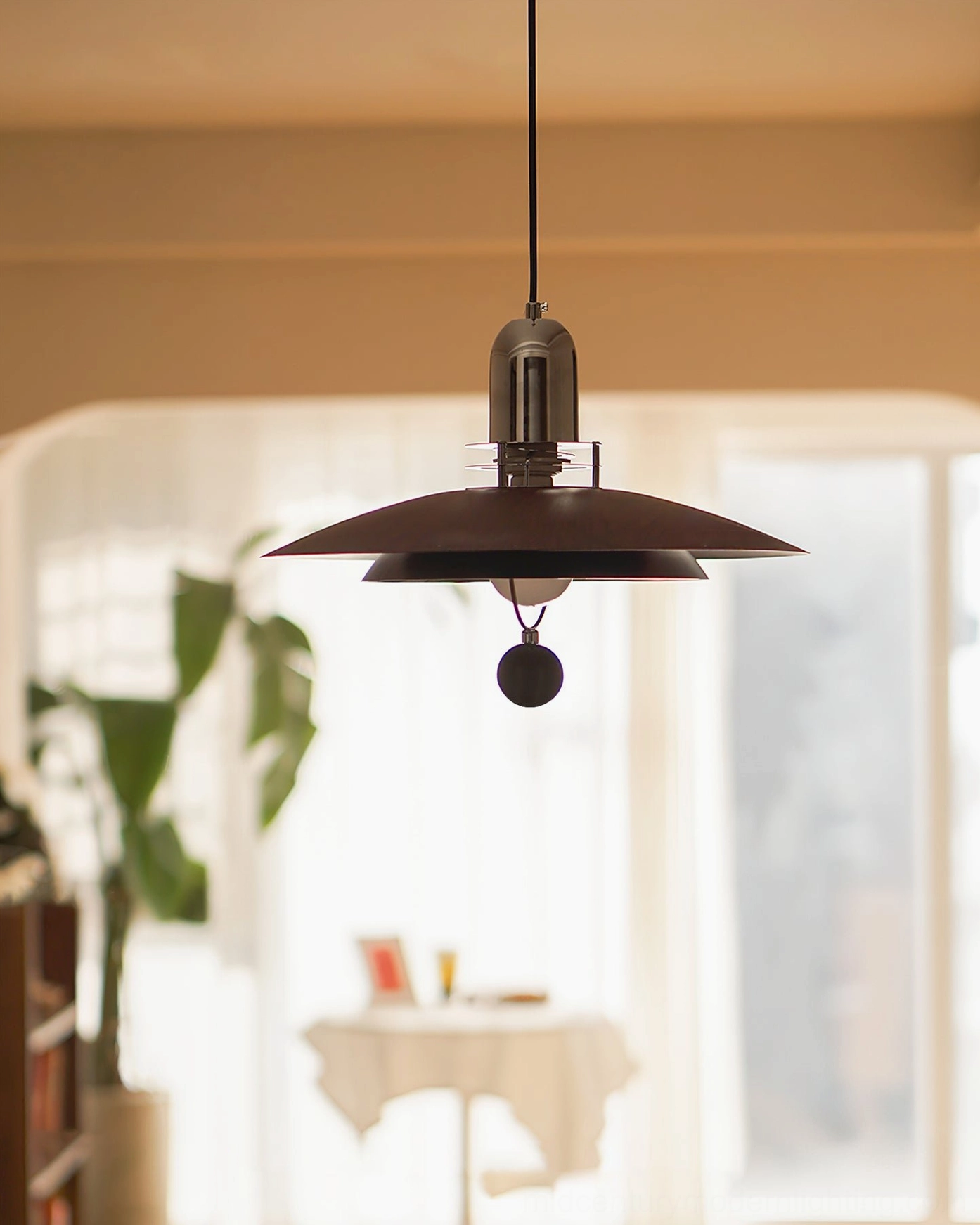 Belid pendant lamp in sunlit dining nook, dark brown shade black metal hardware ambient lighting