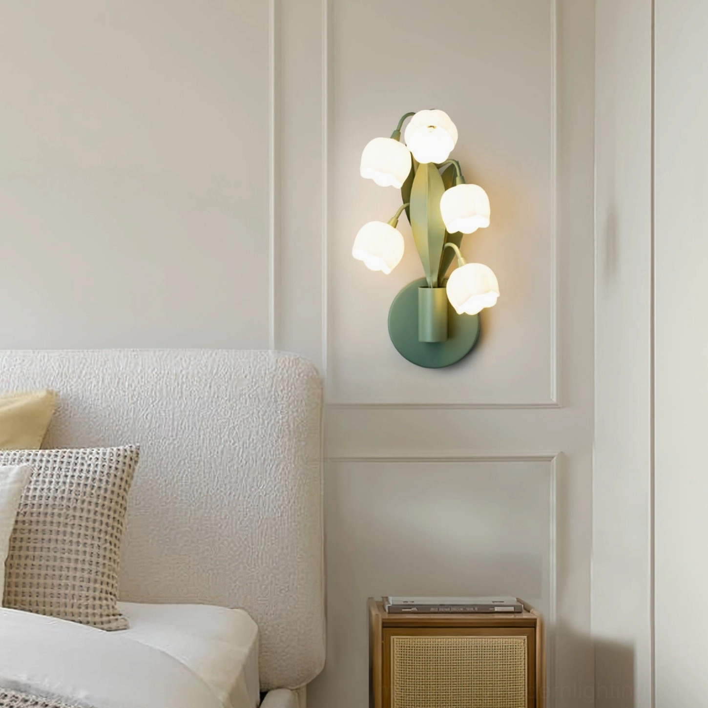 Bell Orchid wall lamp installed as bedside lighting fixture in minimalist French bedroom with soft ambient glow