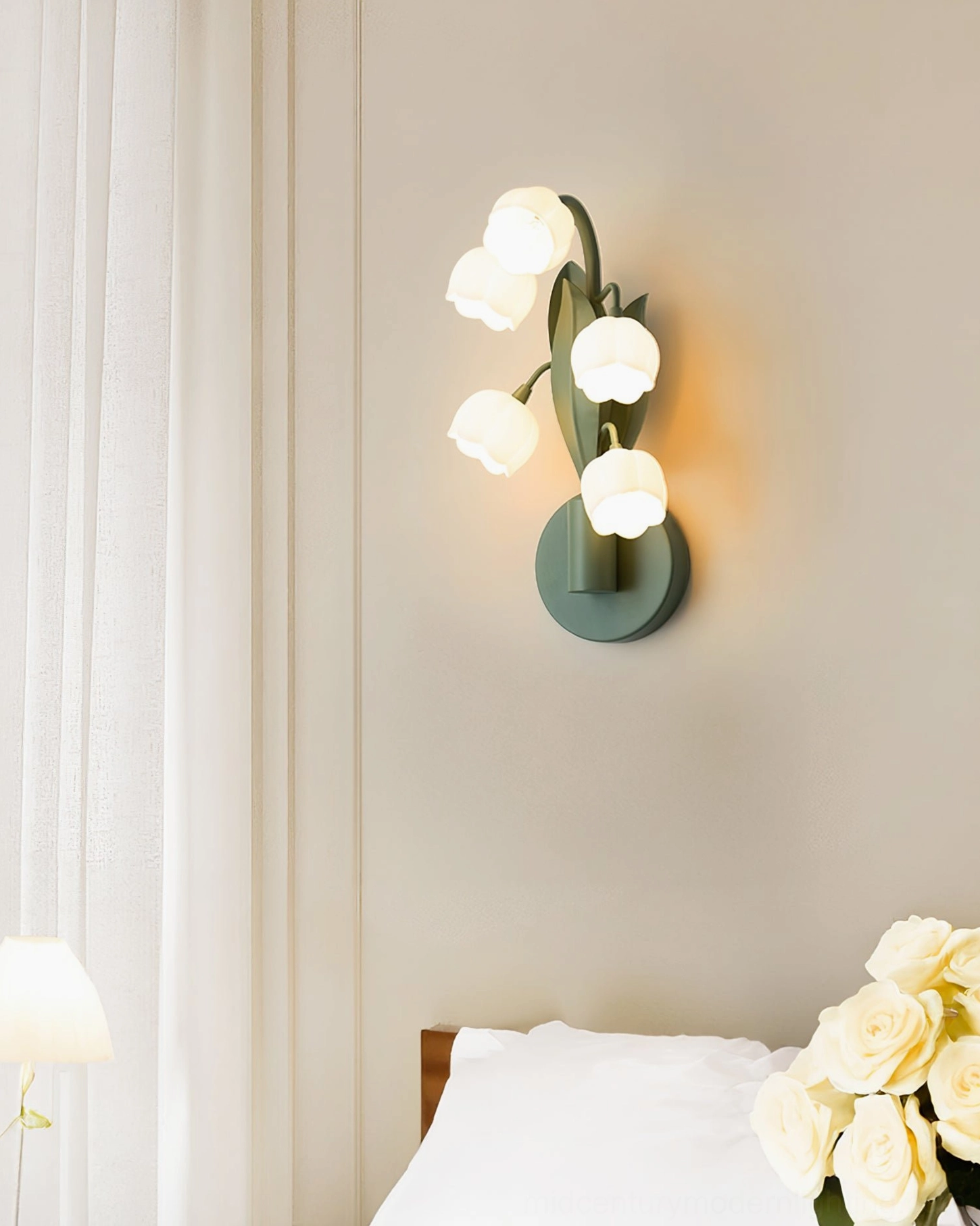 Bell Orchid Lily of the Valley wall lamp three-quarter view showing metal stem and circular wall plate mounting