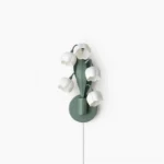 Bell Orchid plug-in wall lamp with six white bell-shaped blooms on matte green stems, front studio view on white background