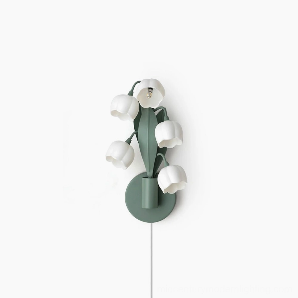 Bell Orchid plug-in wall lamp with six white bell-shaped blooms on matte green stems, front studio view on white background