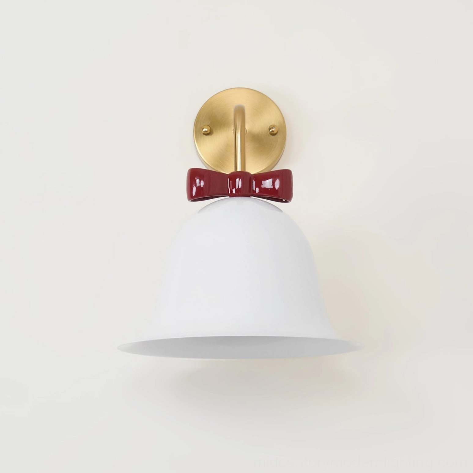 Bell wall lamp close-up showing decorative bow detail and metal craftsmanship