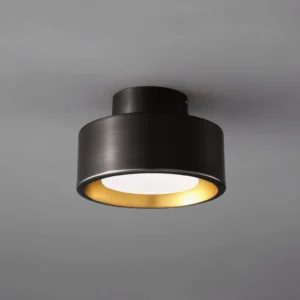 Overhead close-up of Bella black and gold flush mount ceiling lamp showing matte black exterior with brushed gold interior trim