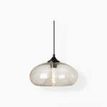 Bella hand-blown glass pendant lamp with clear glass shade and black metal canopy, front view on white background