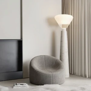 Bella marble floor lamp three-quarter view living room gray sofa scandinavian design