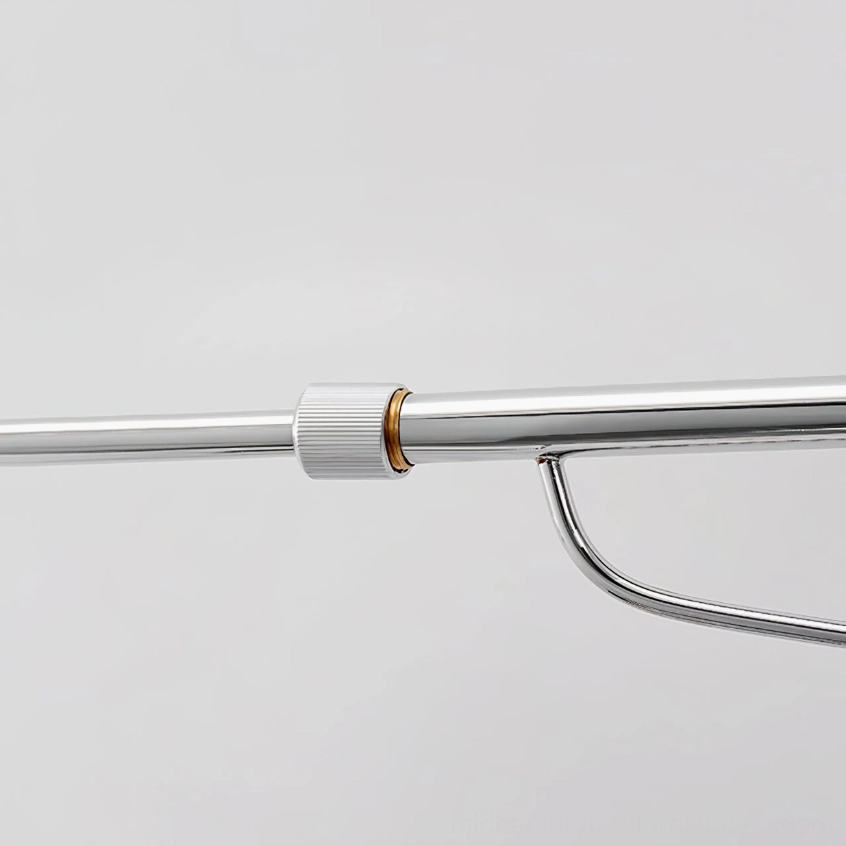 Bedside reading lamp with adjustable arm extended over headboard