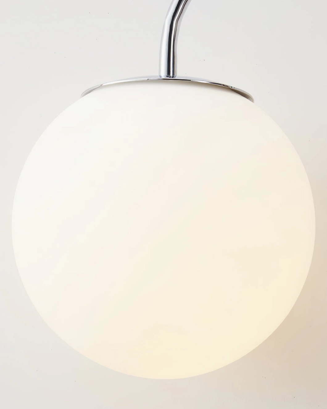 Modern industrial chrome wall sconce in minimalist loft environment