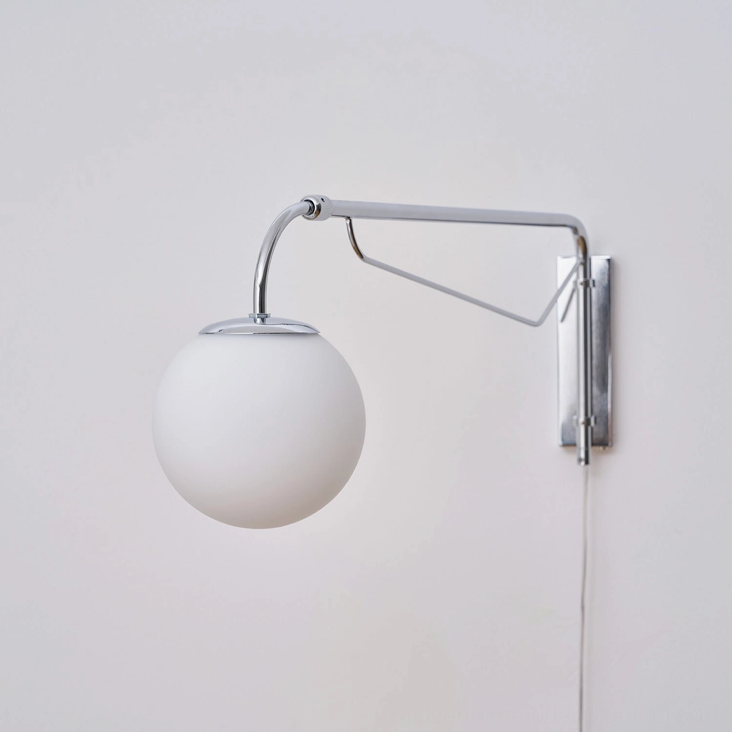 Minimalist swing arm sconce interior design styling and room integration