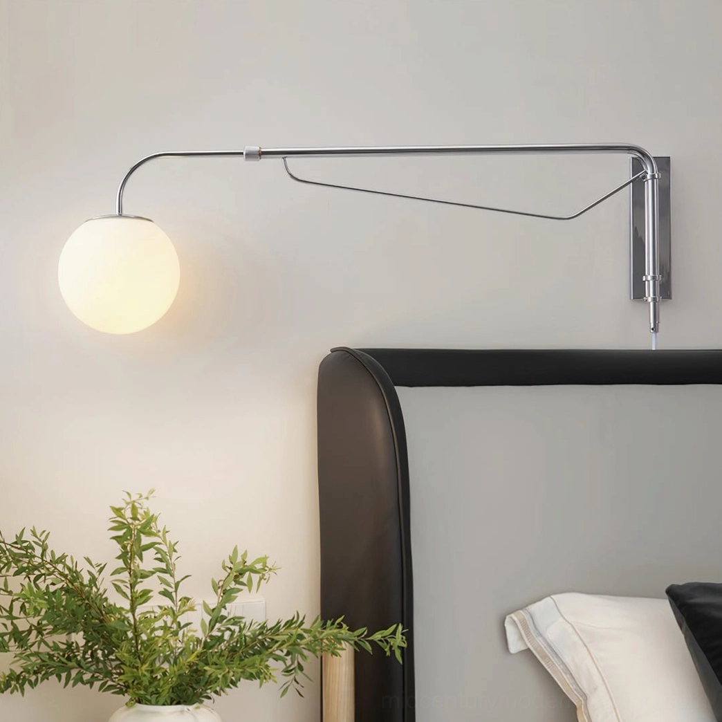 Chrome swing arm wall lamp rotatable mount showing full articulation capability