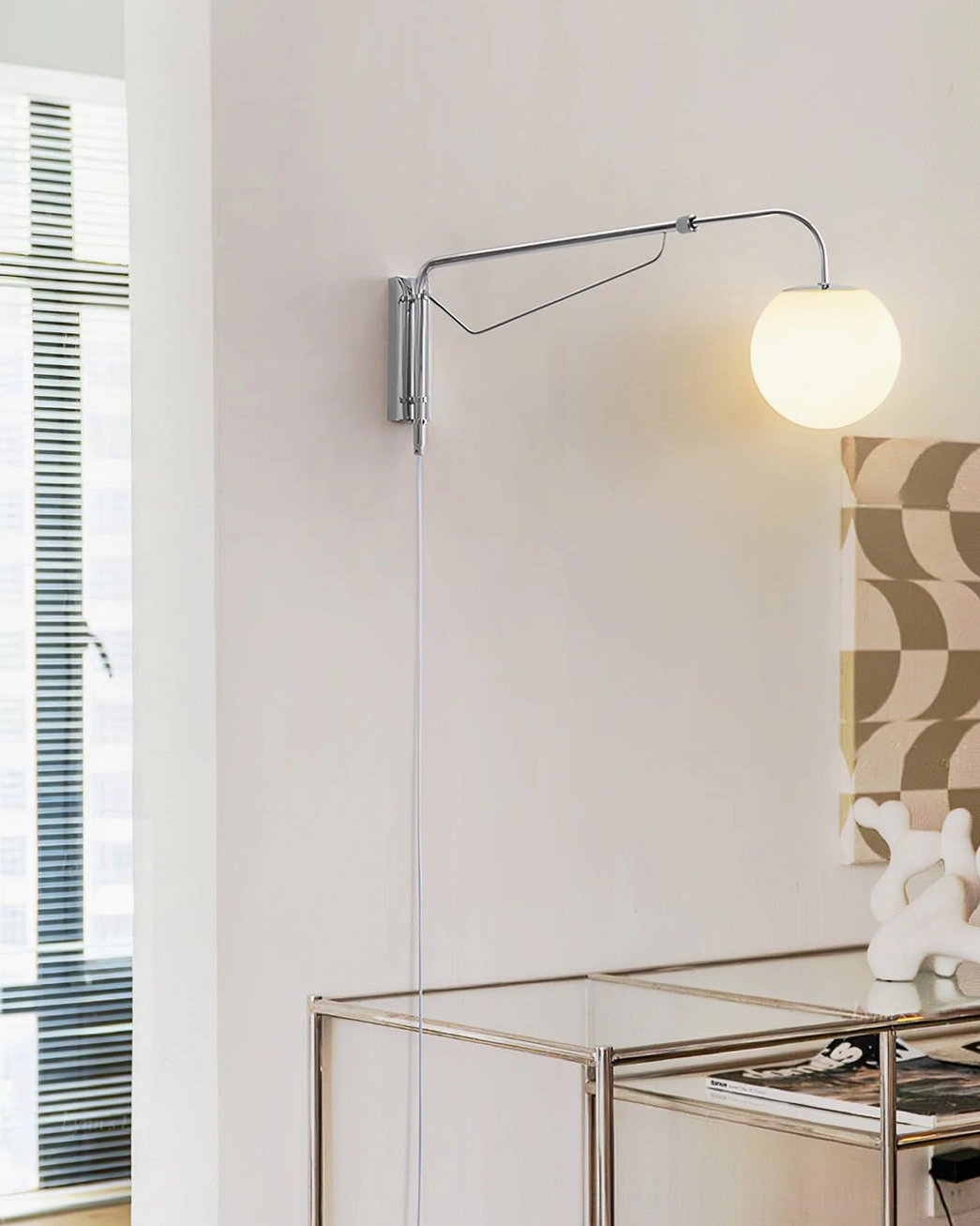 Contemporary swing arm sconce positioned over geometric accent wall in minimalist study corner