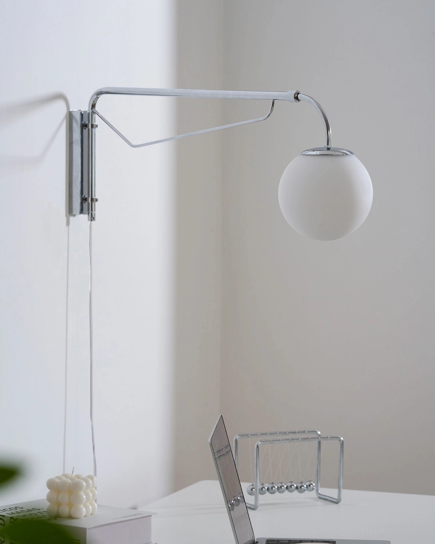 Matte white telescoping wall sconce in Scandinavian bedroom setting