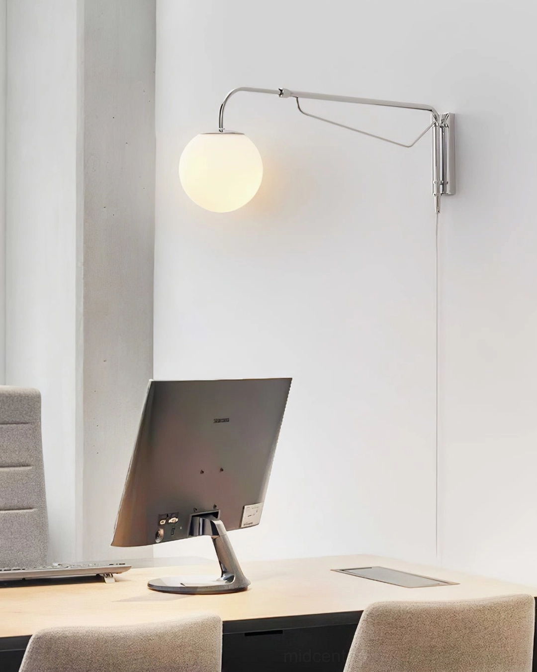 Mid-century modern wall-mounted reading light above home office desk with monitor