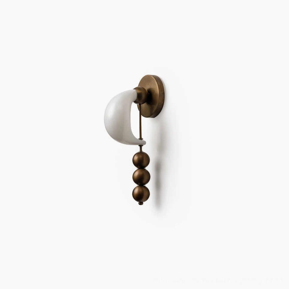 Bent glass wall lighting fixture demonstrating artisanal glass forming technique and sculptural metal base assembly