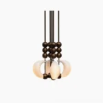 Bent glass pendant light close-up detail showing curved milky white opal glass shade with antique brass spherical accents - modern sculptural chandelier