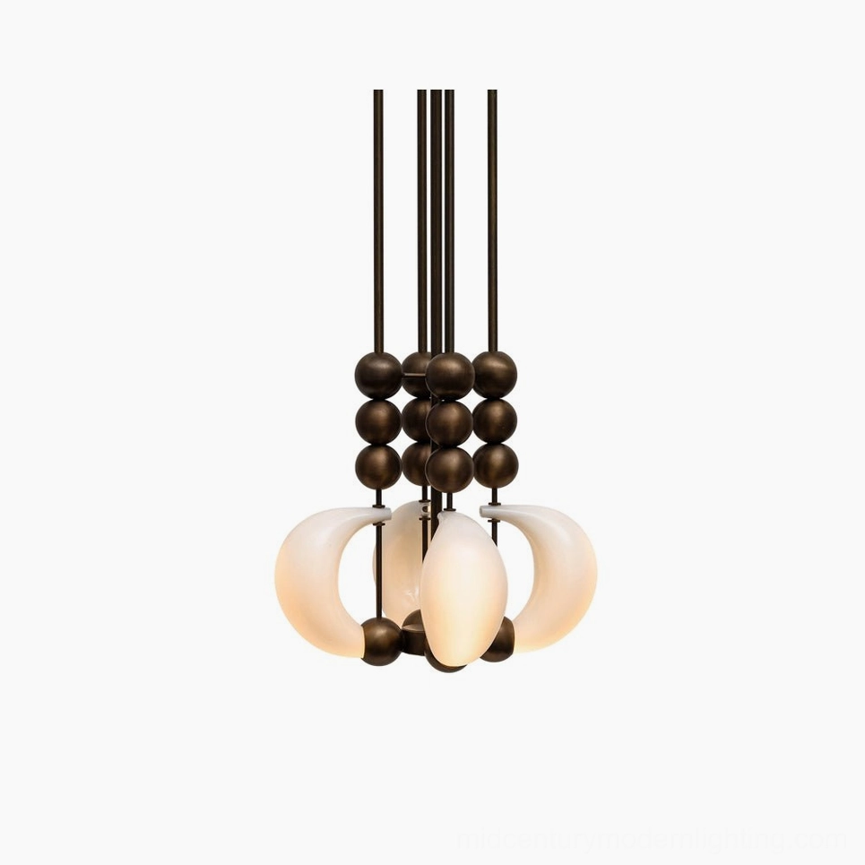 Bent glass pendant light close-up detail showing curved milky white opal glass shade with antique brass spherical accents - modern sculptural chandelier