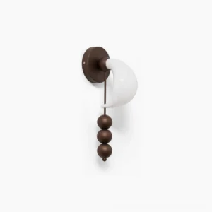 Bent glass wall sconce with hand-formed curved glass shade and three sculptural brass spheres, antique brass finish on white background