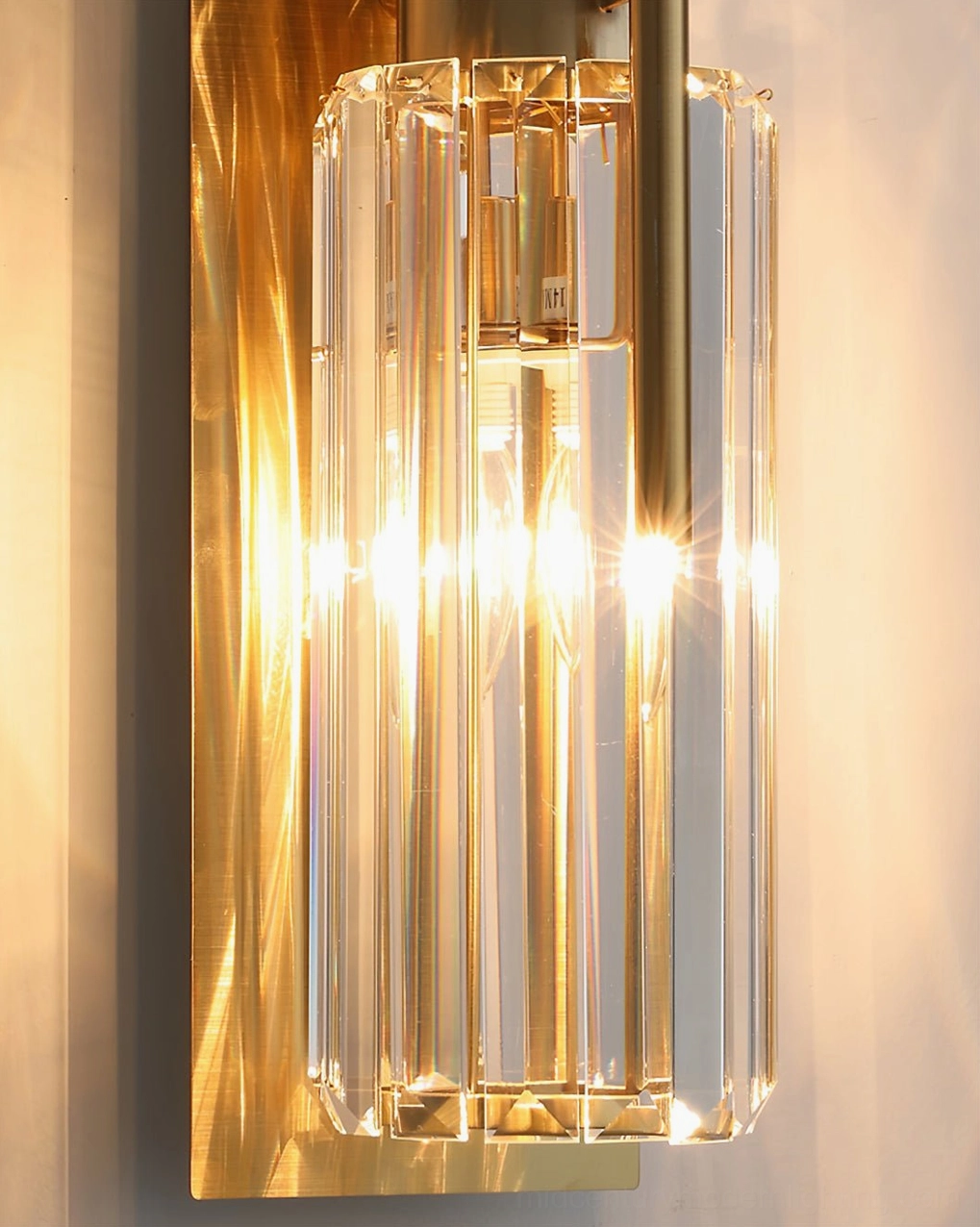 Bepuzz Wall Sconce extreme close-up – hand-chiseled crystal facets with warm golden light refraction