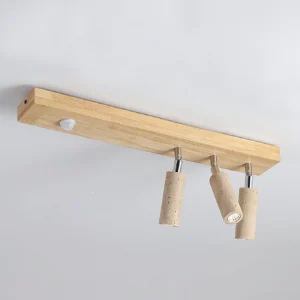 Top-down oblique view of Berge wooden track spotlight fixture with three adjustable beige travertine lamp heads