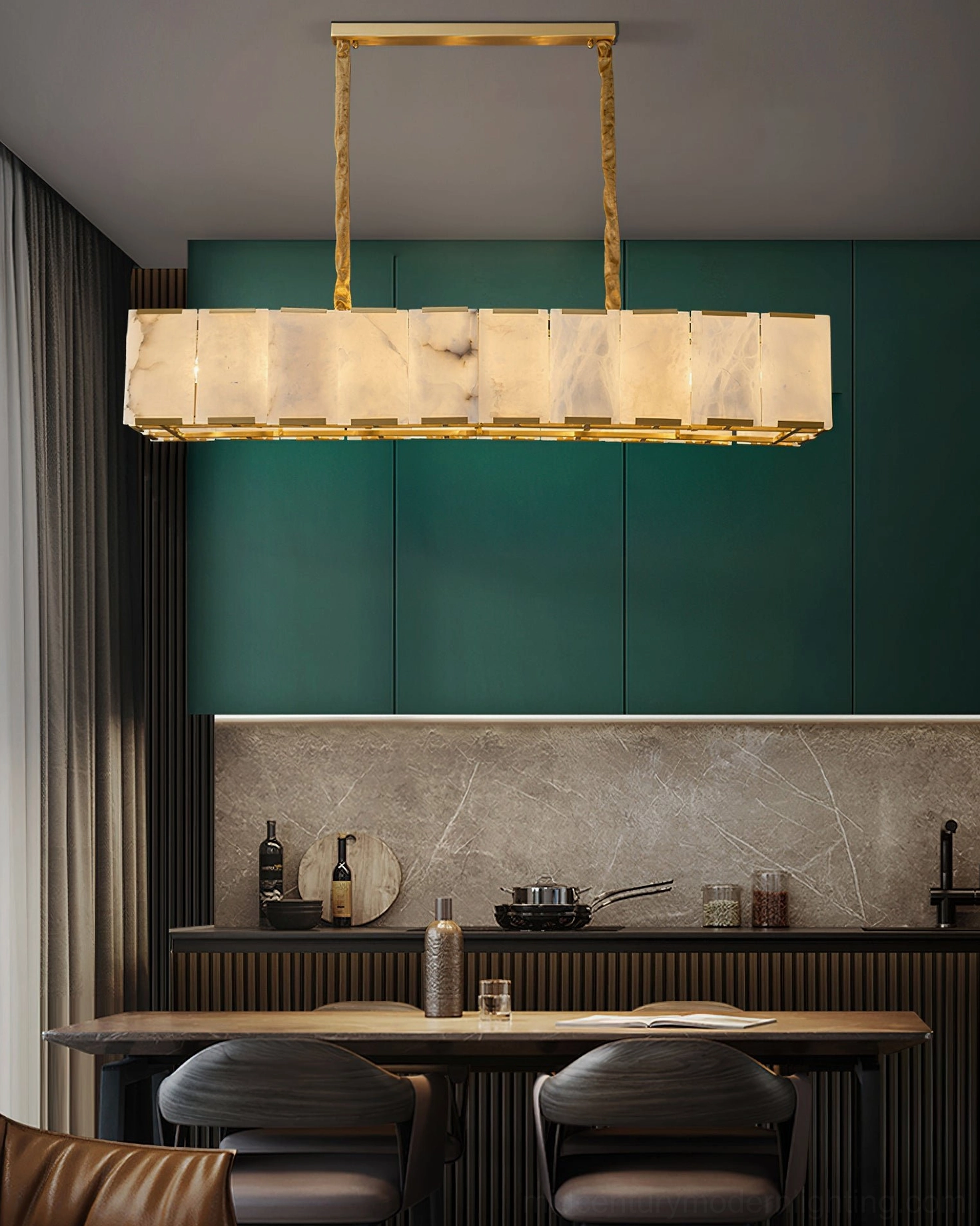 Bernardi linear alabaster chandelier installed over kitchen bar counter with dark green cabinetry and sleek modern kitchen design