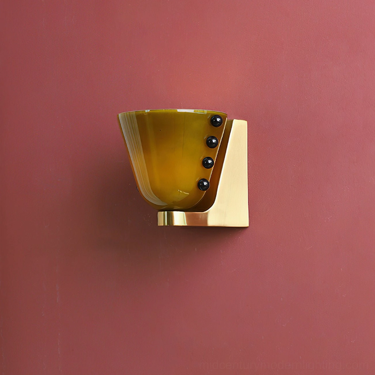 Berries wall lamp with yellow amber glass on burgundy red wall background, brass base with black bead trims