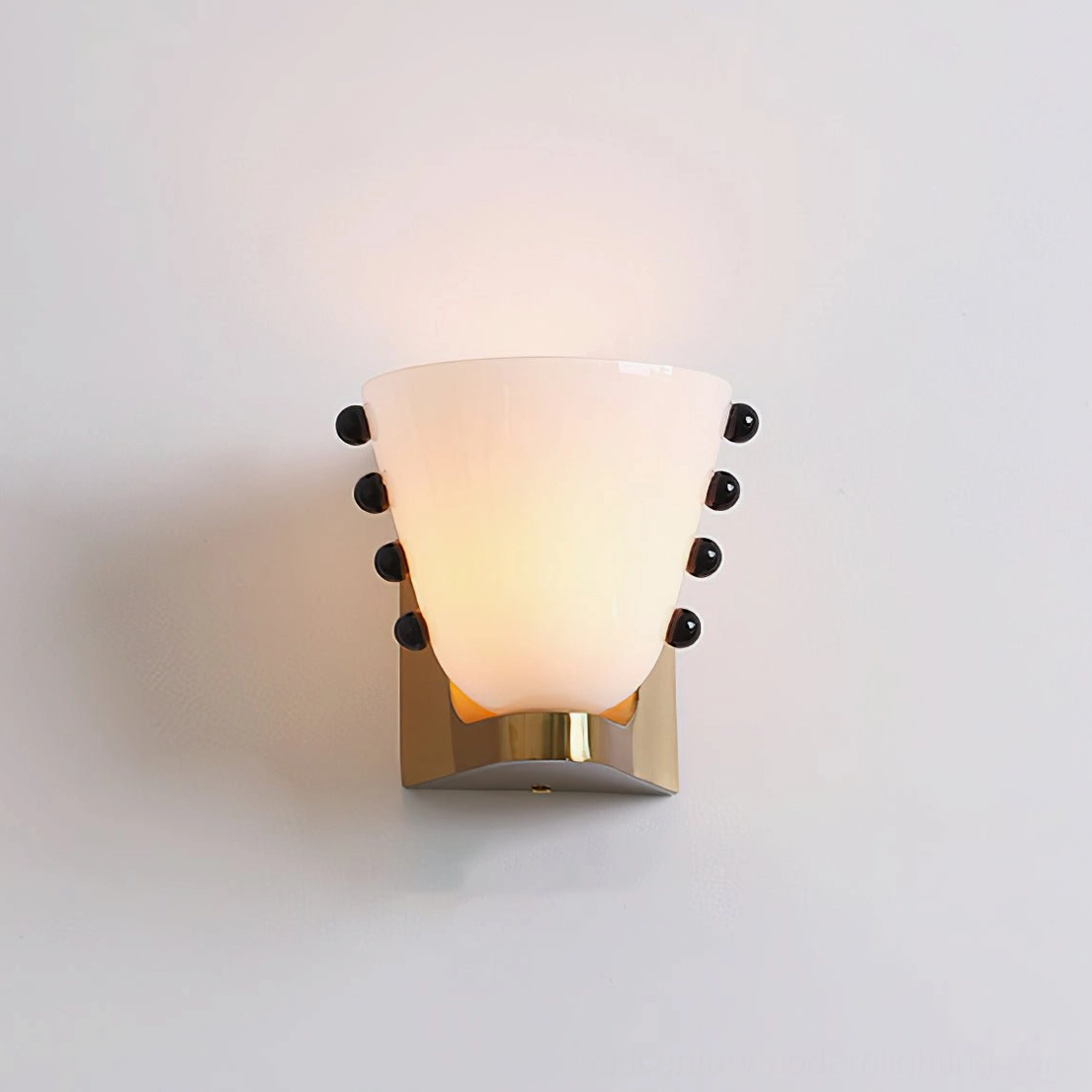 Berries wall lamp detail showing brass base plate connection and premium fixture hardware components