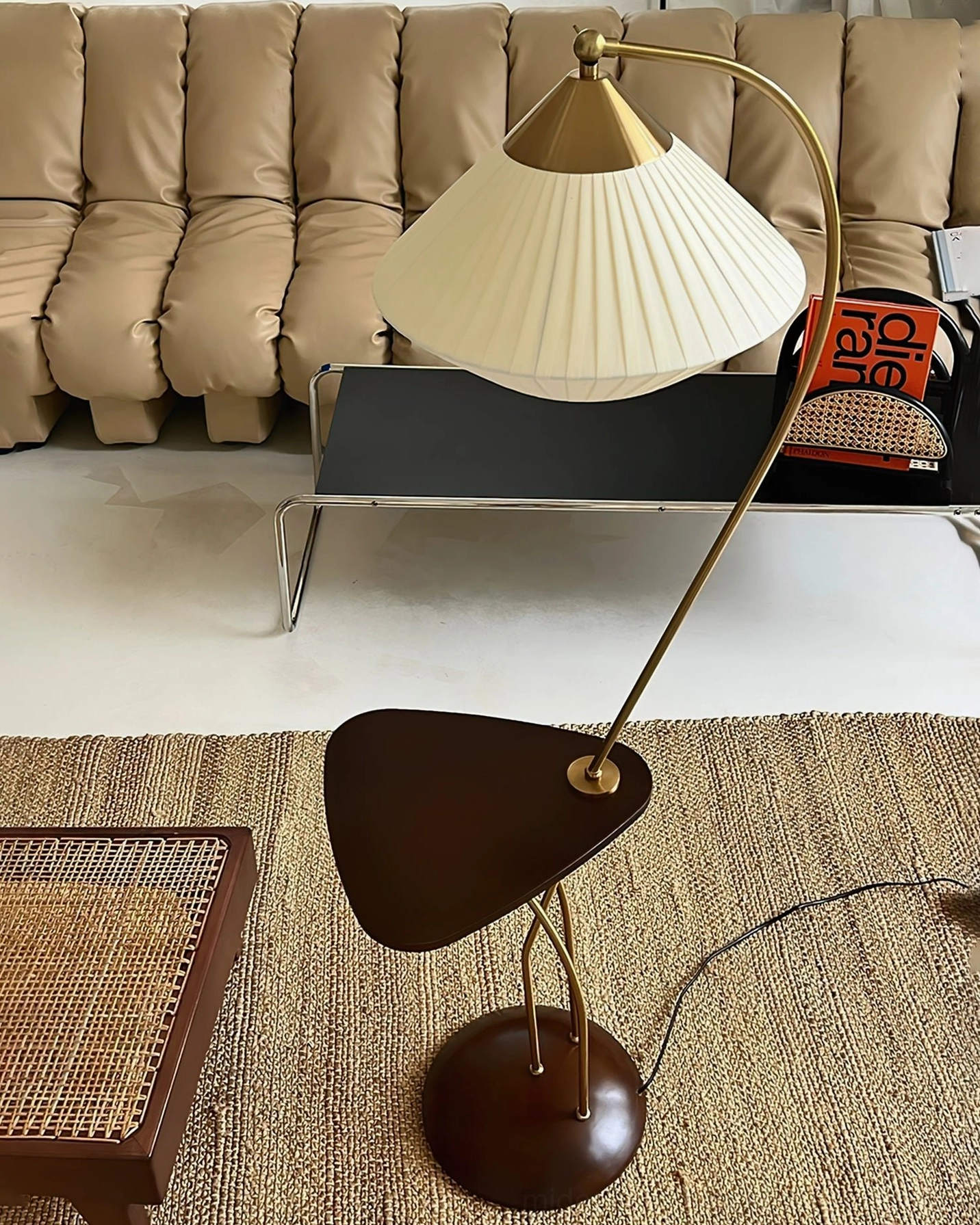 Bertil arc floor lamp showing pleated shade texture and brass arched frame, mid-century modern lighting design