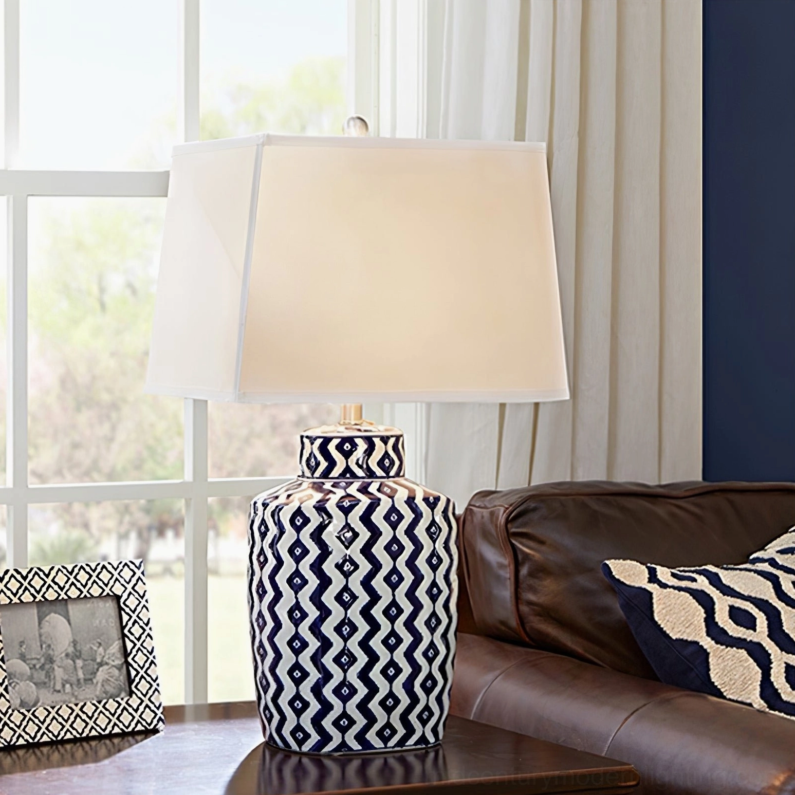 Beryl blue and white decorative table lamp in traditional living room with leather sofa, showcasing interior styling