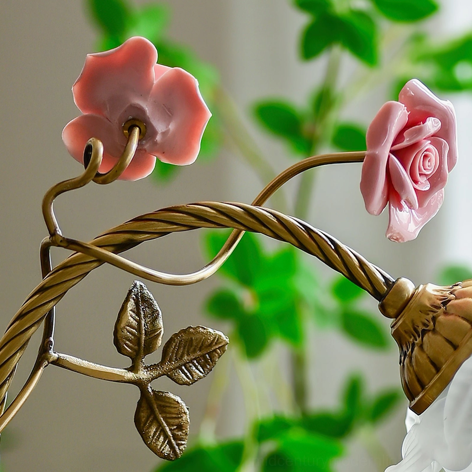 Beulah table lamp showing full profile with pink ceramic florals and brass metalwork craftsmanship