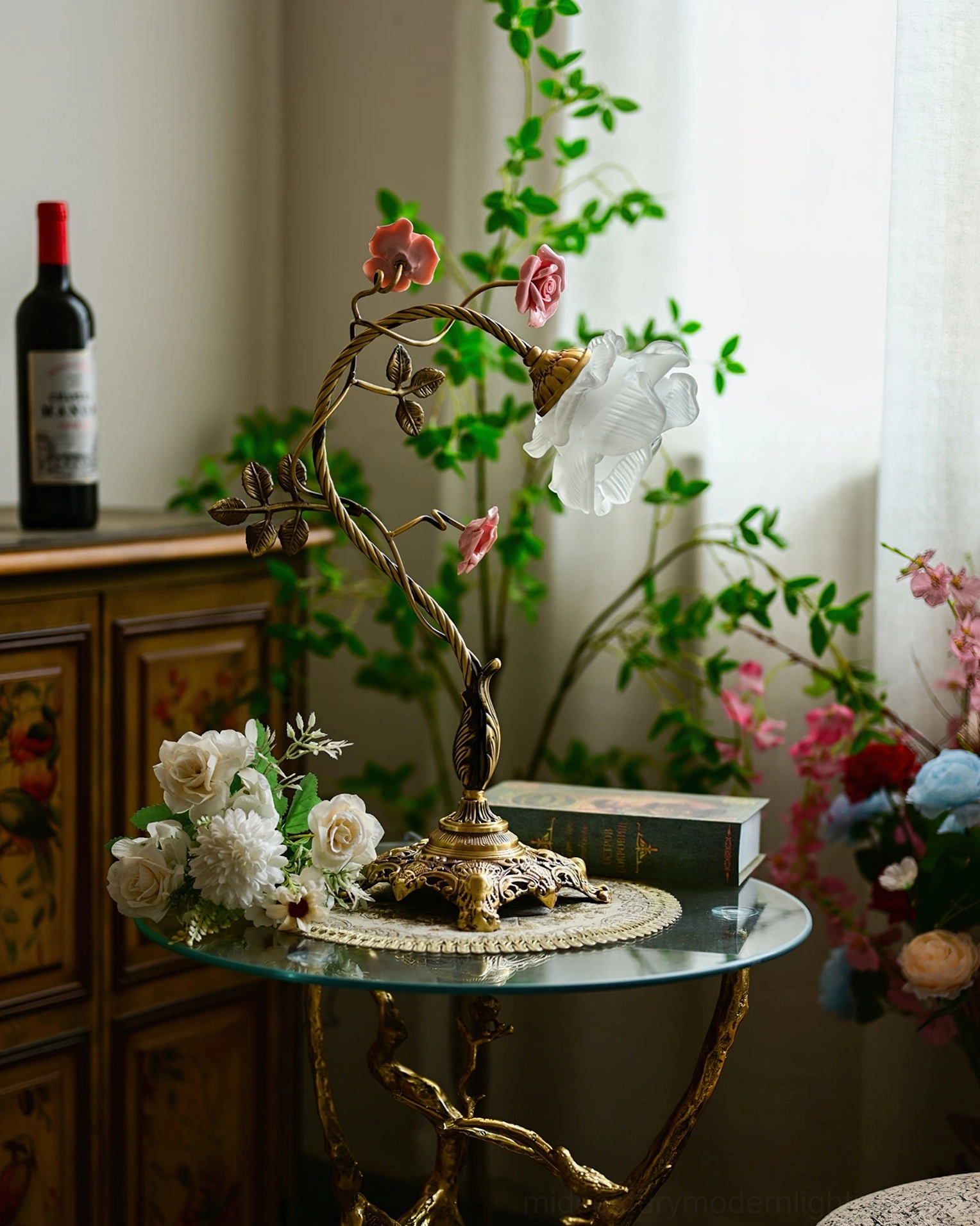 Beulah rose table lamp with white shade in three-quarter view, vintage home setting with red wine and floral decor