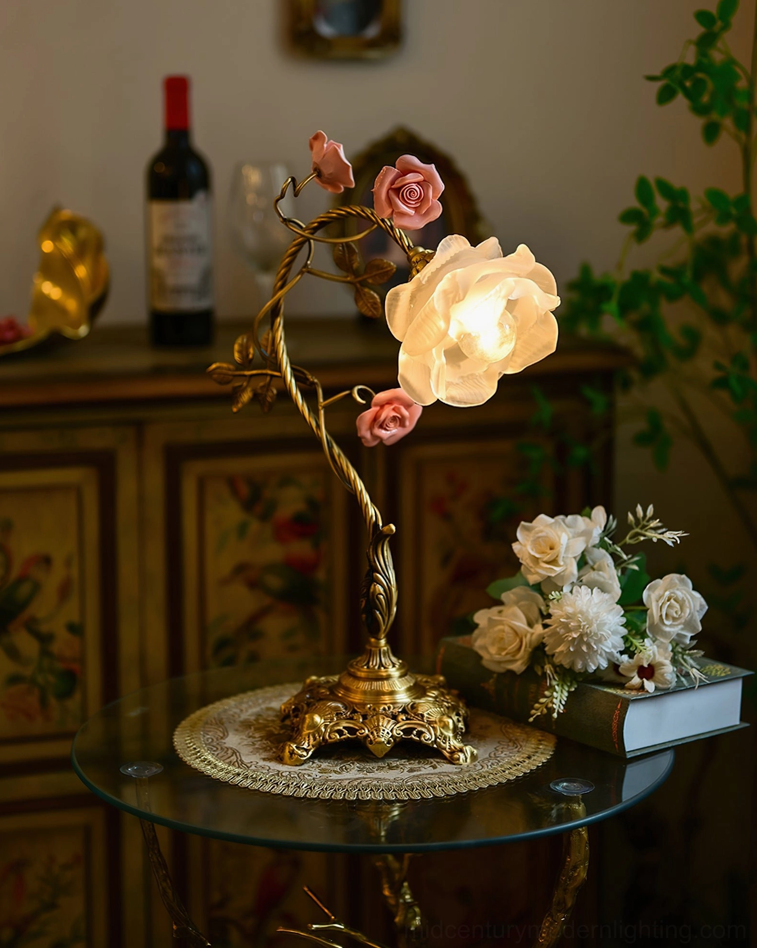 Beulah table lamp illuminated on side table with floral bouquet and vintage home decor arrangement