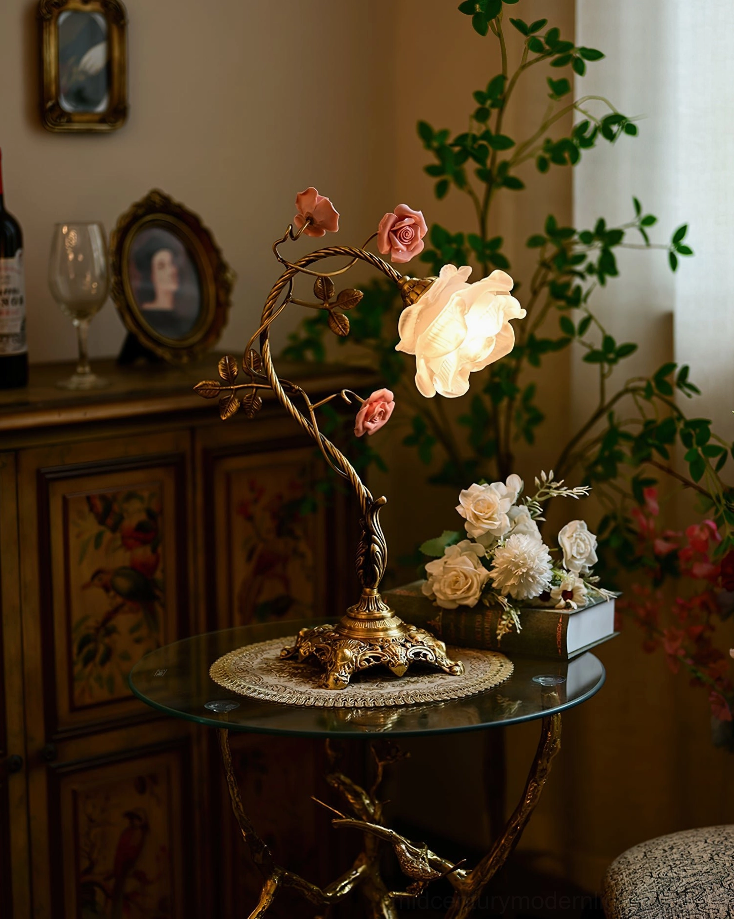 Lit Beulah rose table lamp in vintage home setting with green plant backdrop and side table scene