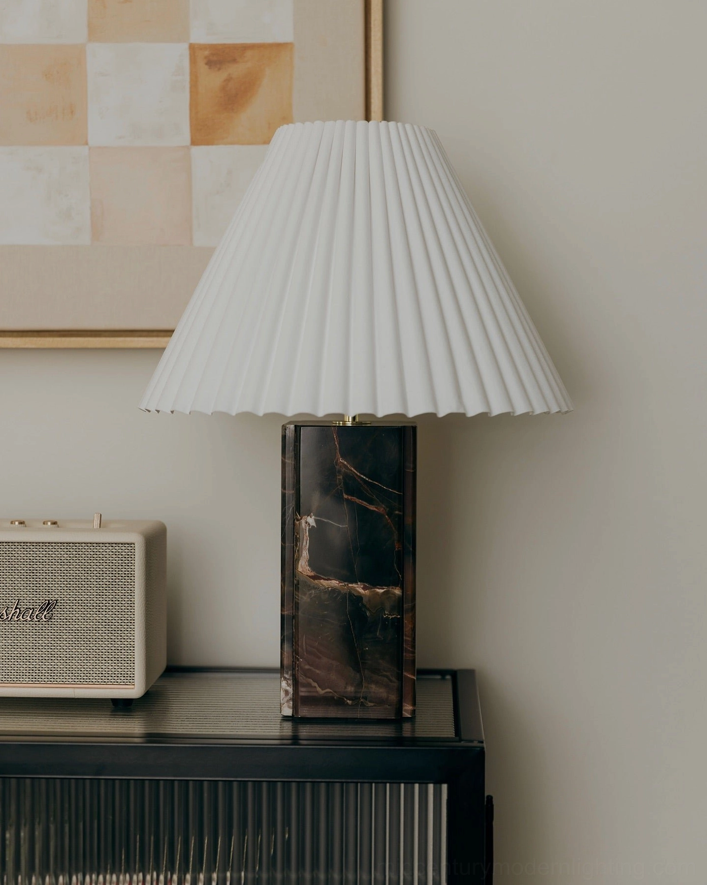 Close-up of Bianca marble lamp showing pleated fabric shade, brass hardware, and striated marble detail