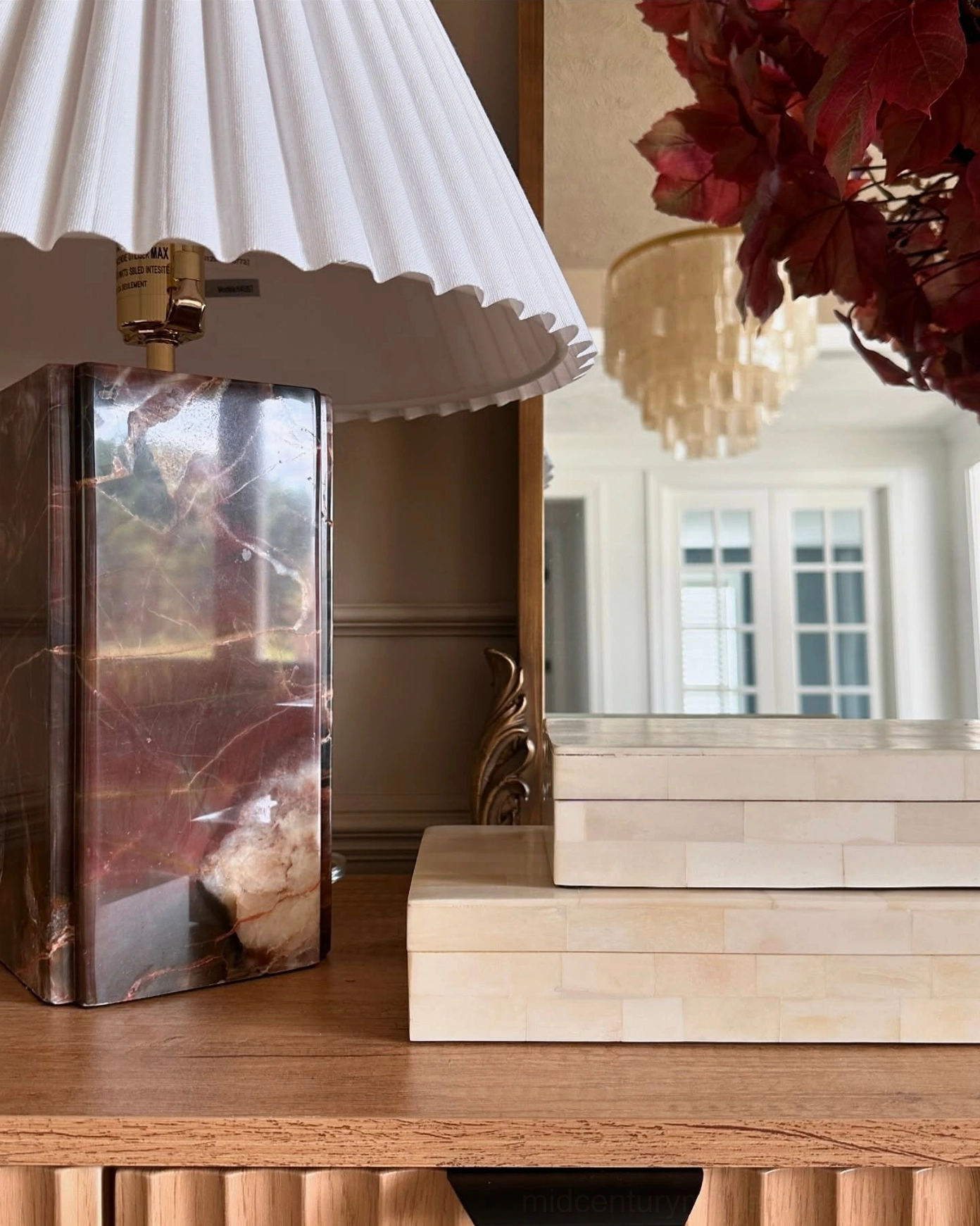 Bianca marble table lamp in modern living room with side cabinet and contemporary wall art