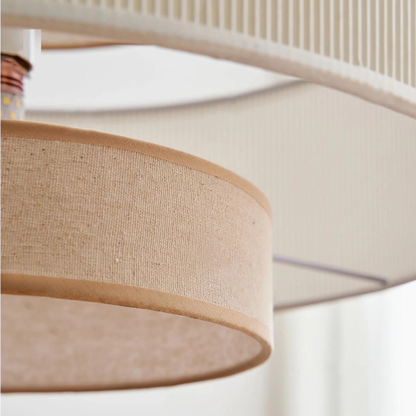 Extreme close-up of Bianella linen shade texture showing pleated edge trim and warm beige fabric detail