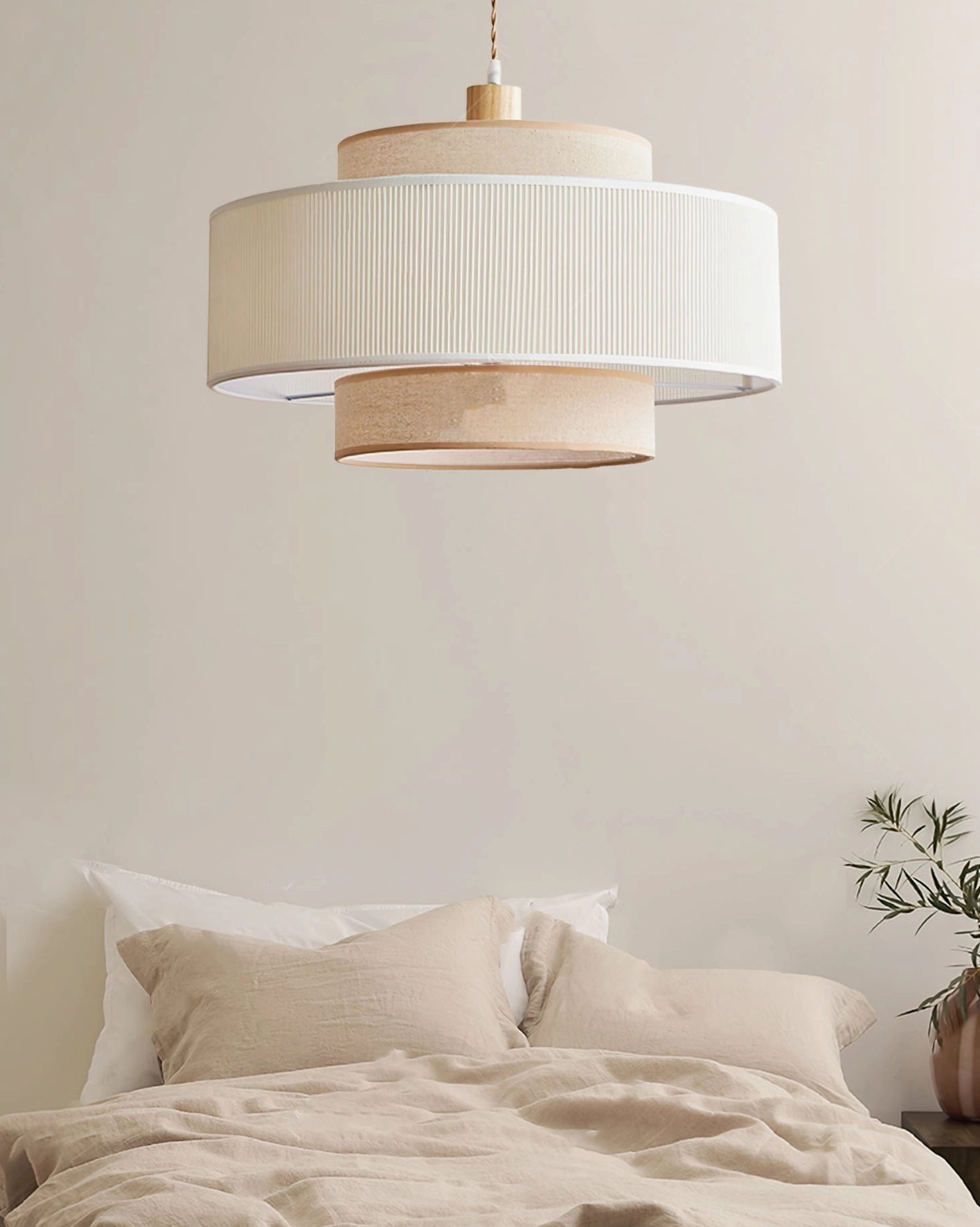 Bianella pendant lamp in bedroom overhead view with linen bedding, off-white pleated shade minimalist decor