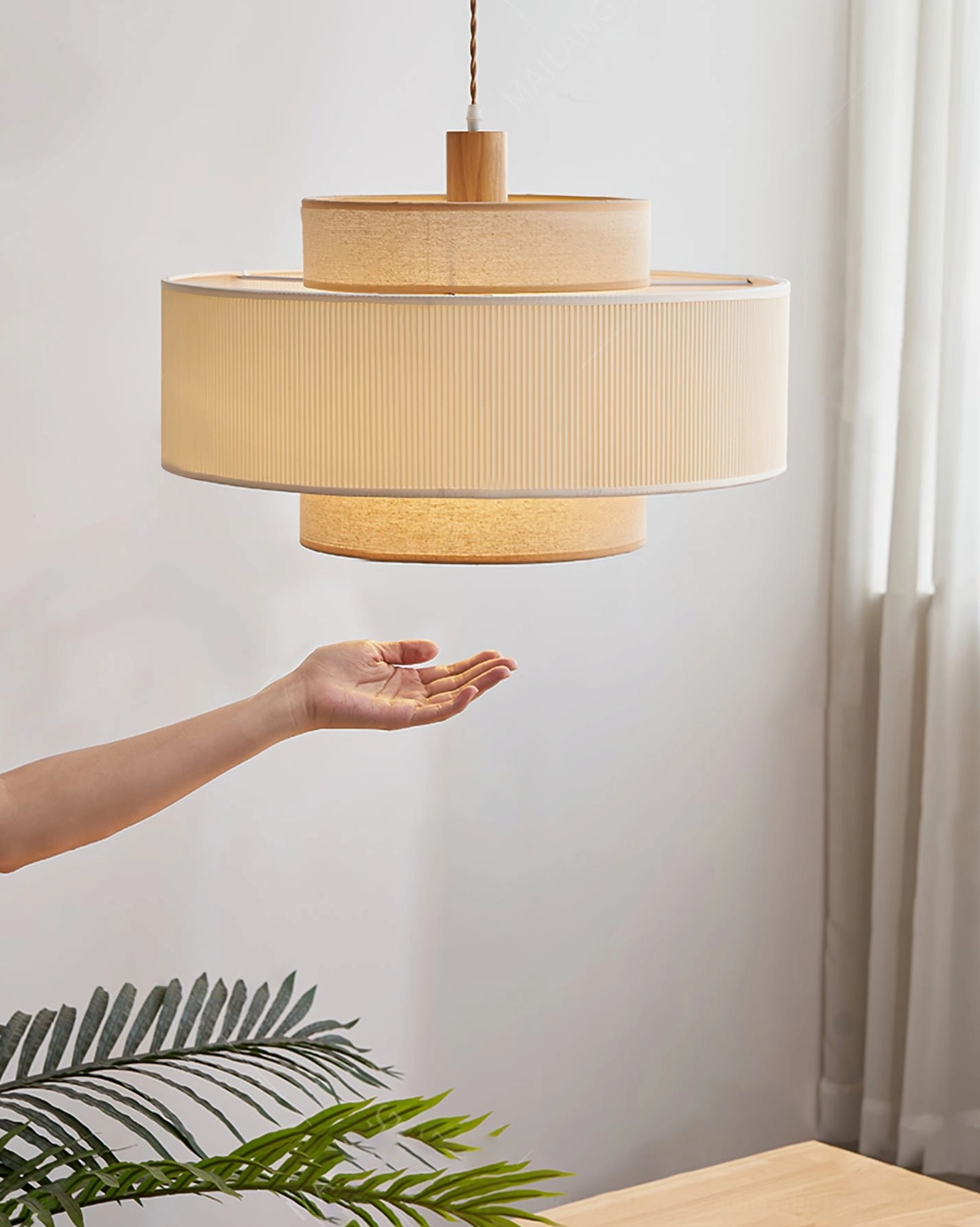 Bianella pendant lamp hanging in dining corner with hand scale reference, showing minimalist japandi design in home interior