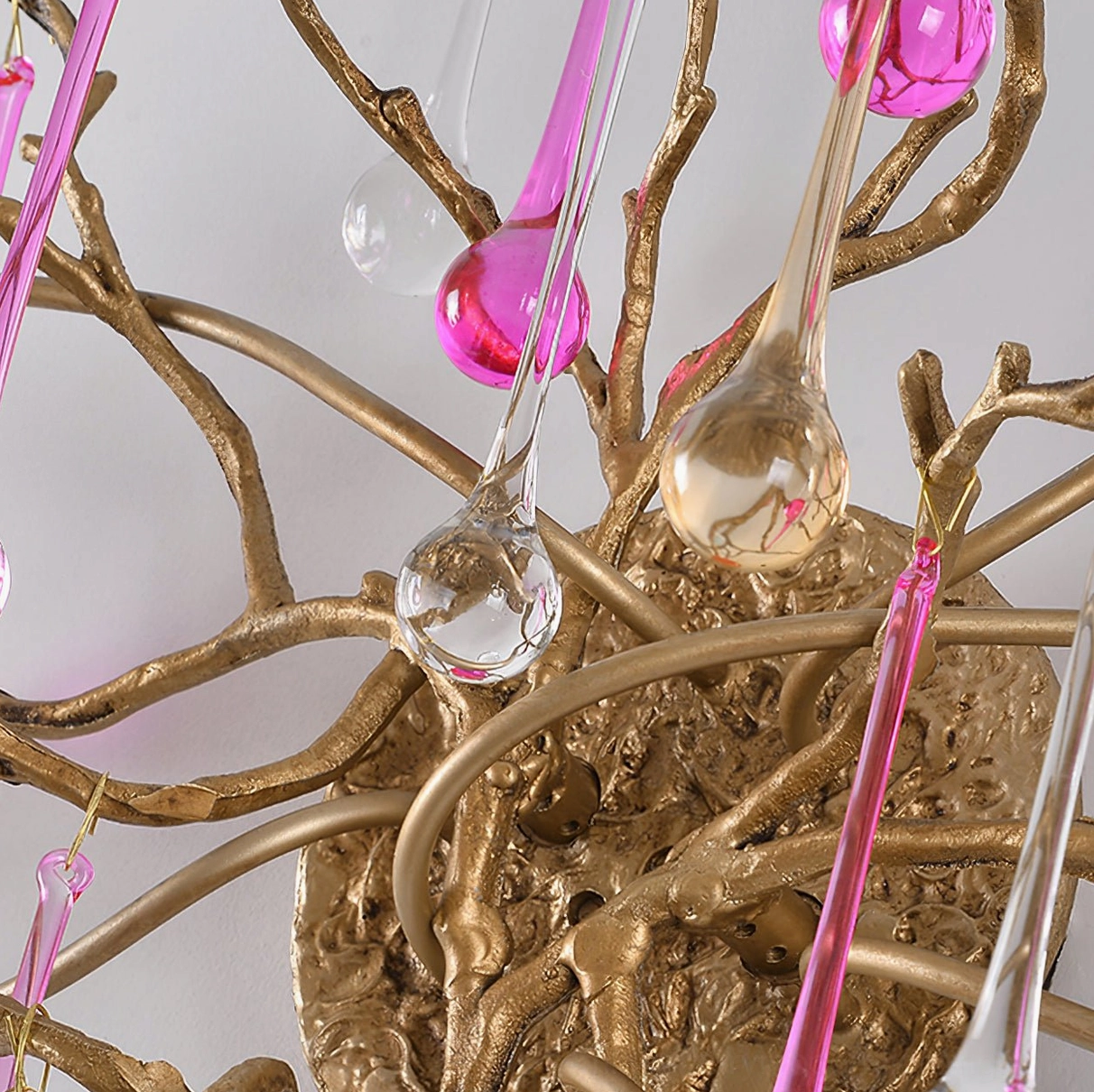Close-up detail of Bijout wall lamp brass metalwork and colored glass droplet ornaments