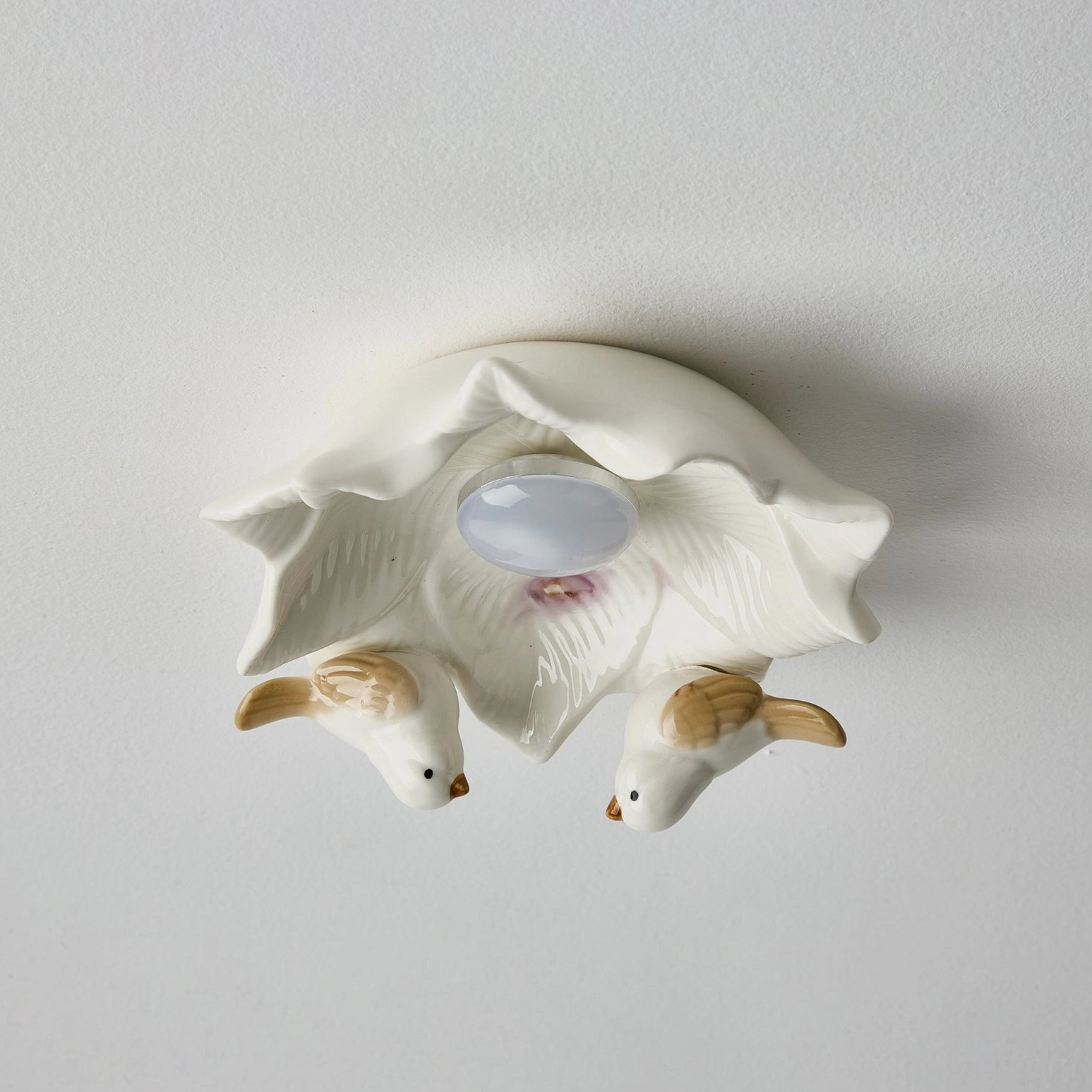 Close-up overhead view of Bilal Bird ceiling light fixture revealing intricate bird details and central light diffuser