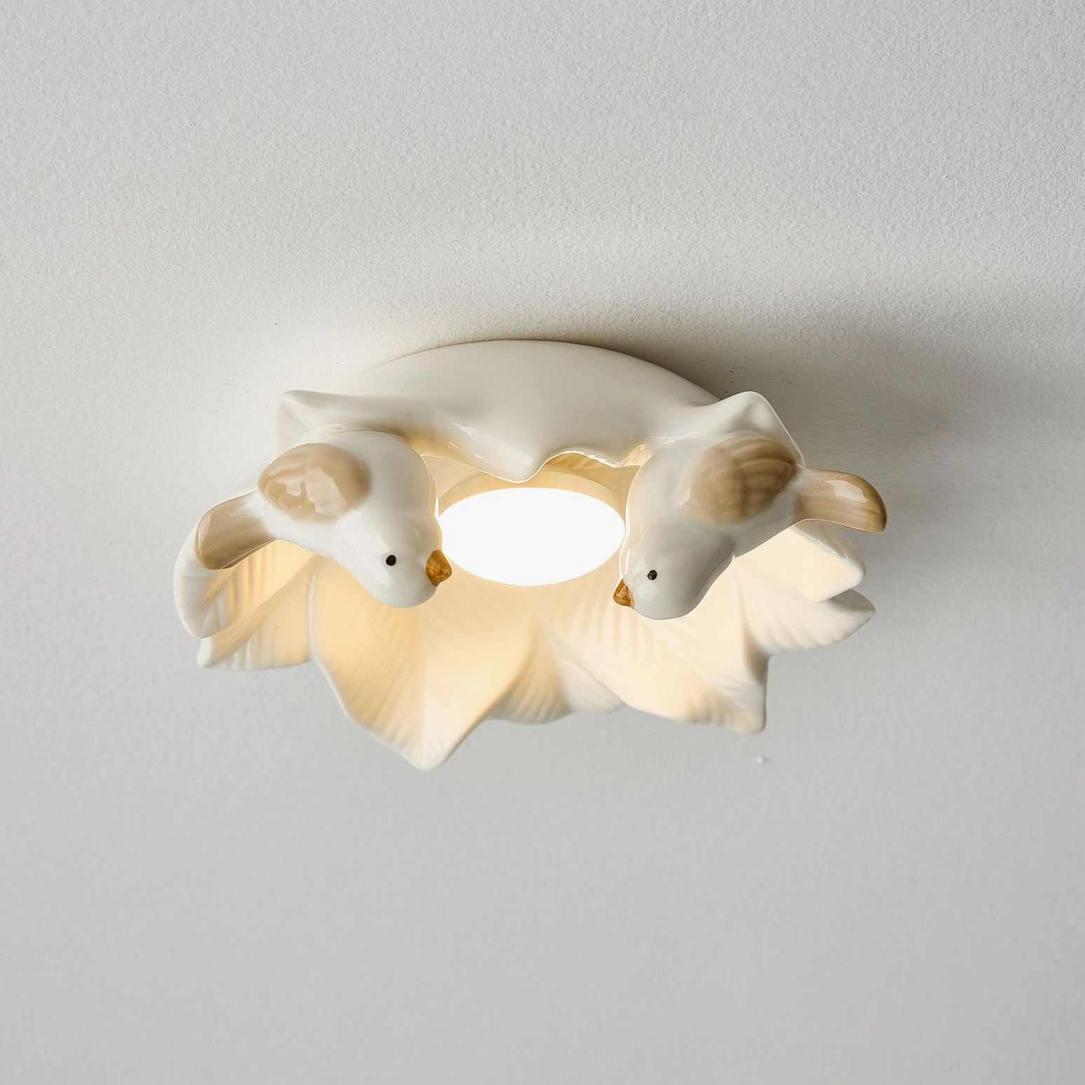 Bilal Bird ceiling fixture overhead angle revealing bird positioning on nest-form ceramic frame construction