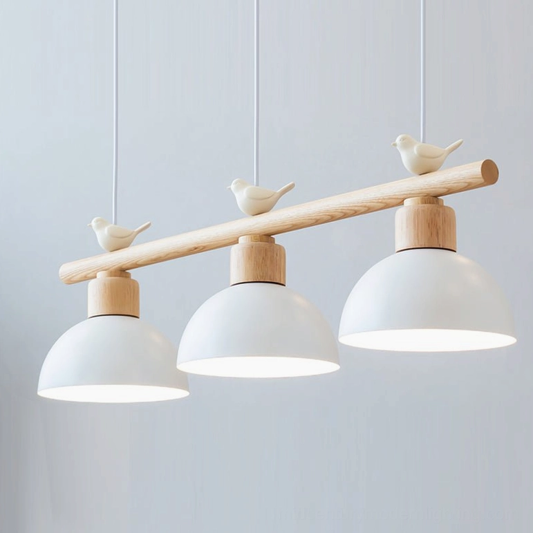 Close-up detail of matte white dome lampshade and wooden hanging rod with bird ornament on three-head pendant chandelier